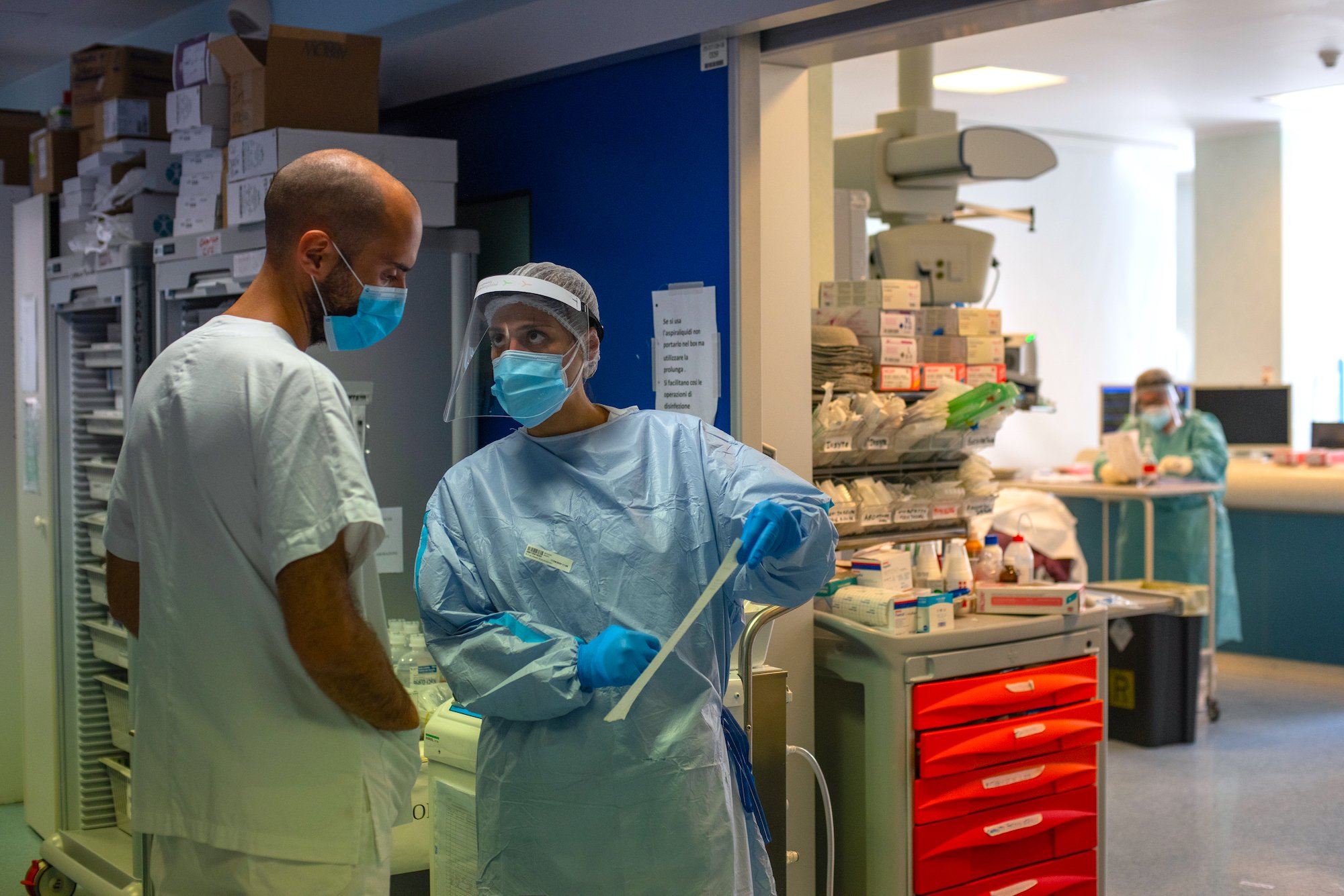 17 September 2020: Health workers discuss the treatment of a COVID-19 patient at the COVID ICU at the St. Orsola-Malpighi Polyclinic in Bologna, Italy.